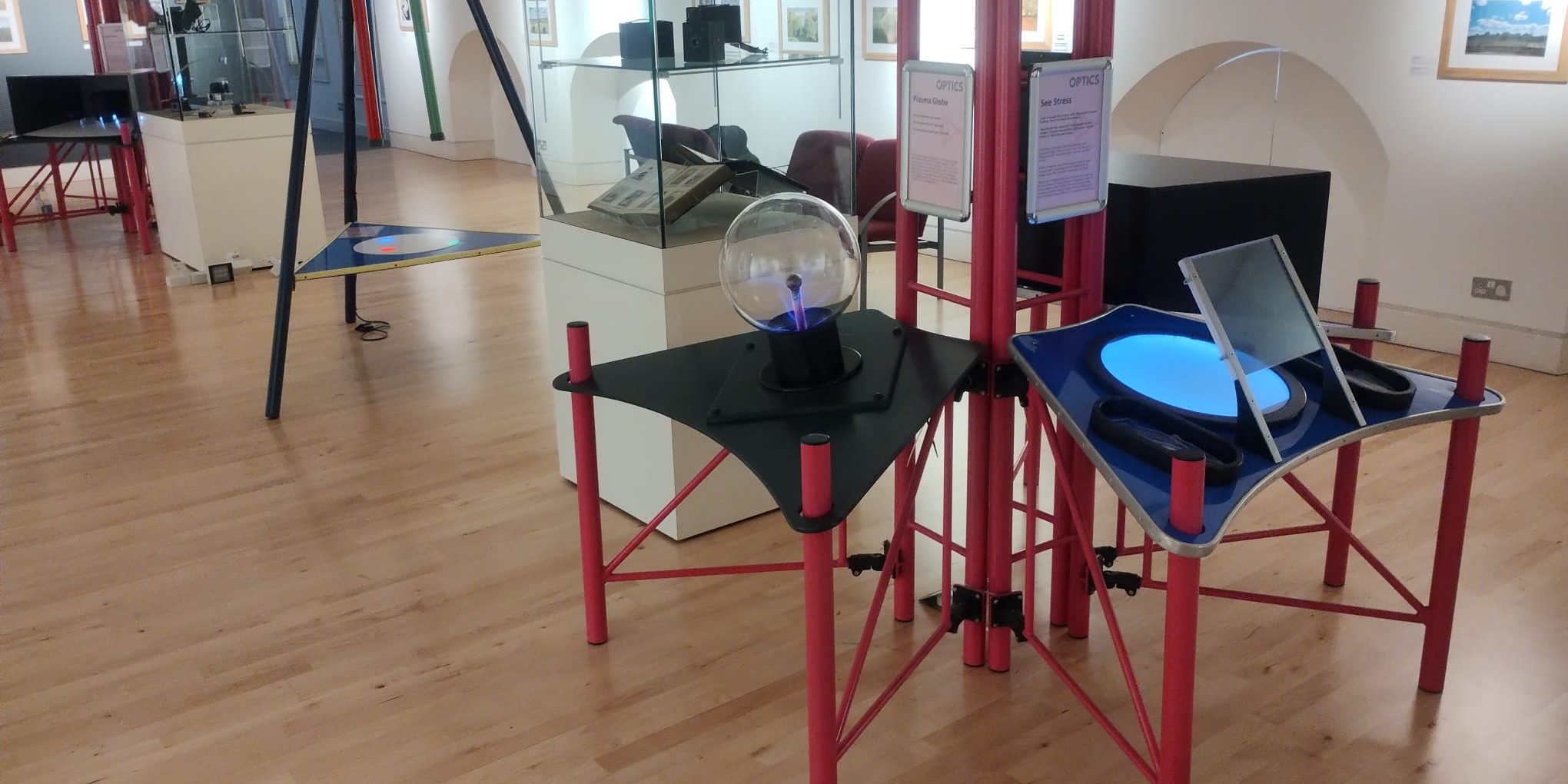 PHOTO-2025-02-14-17-02-55 5 A museum gallery with hands-on interactive science exhibits in the space and photography on the walls.